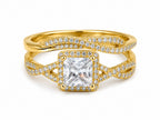 Gold ring with a large diamond and smaller diamonds on a white background