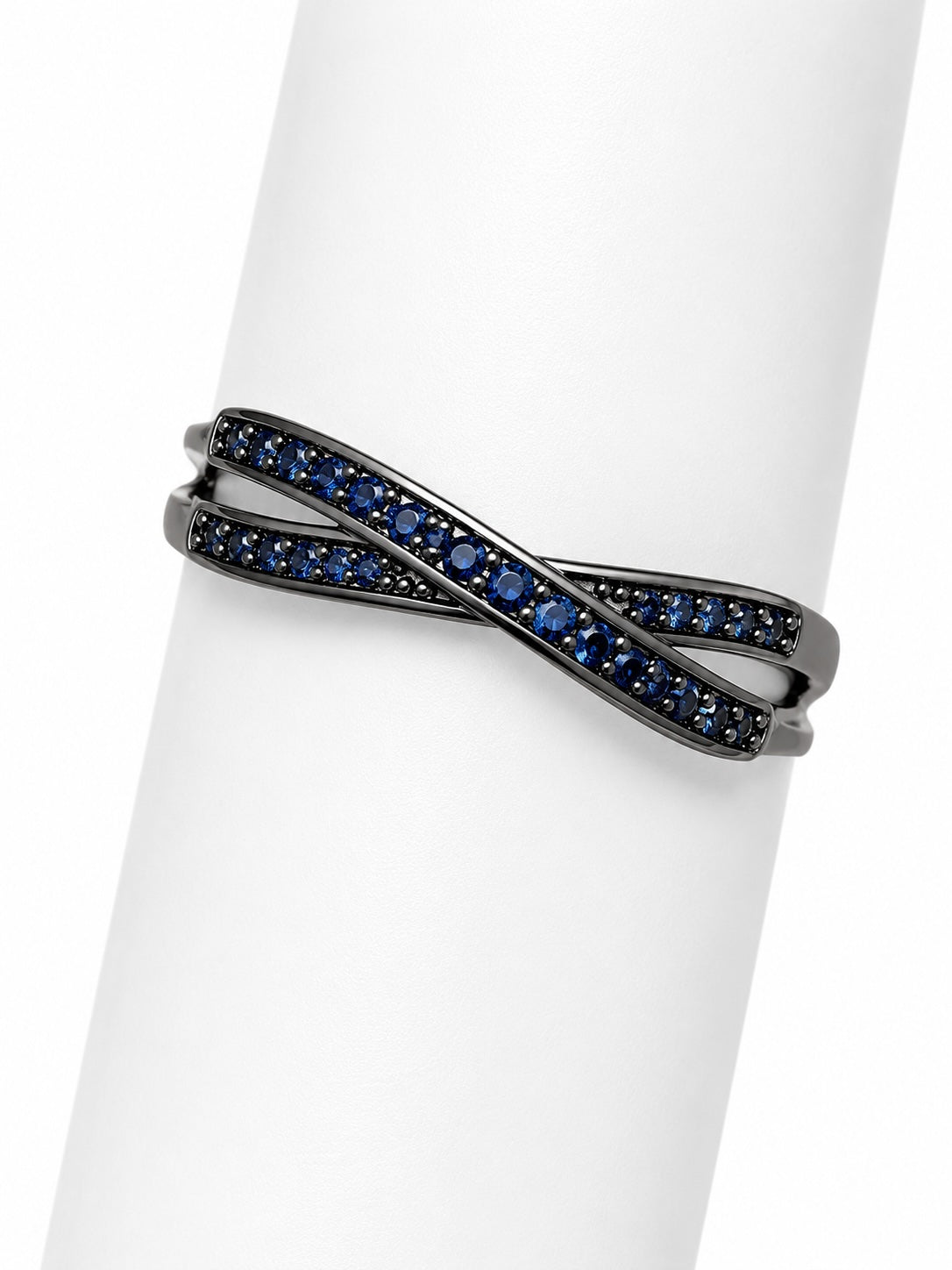 Blackened silver ring with blue gemstones on a white background