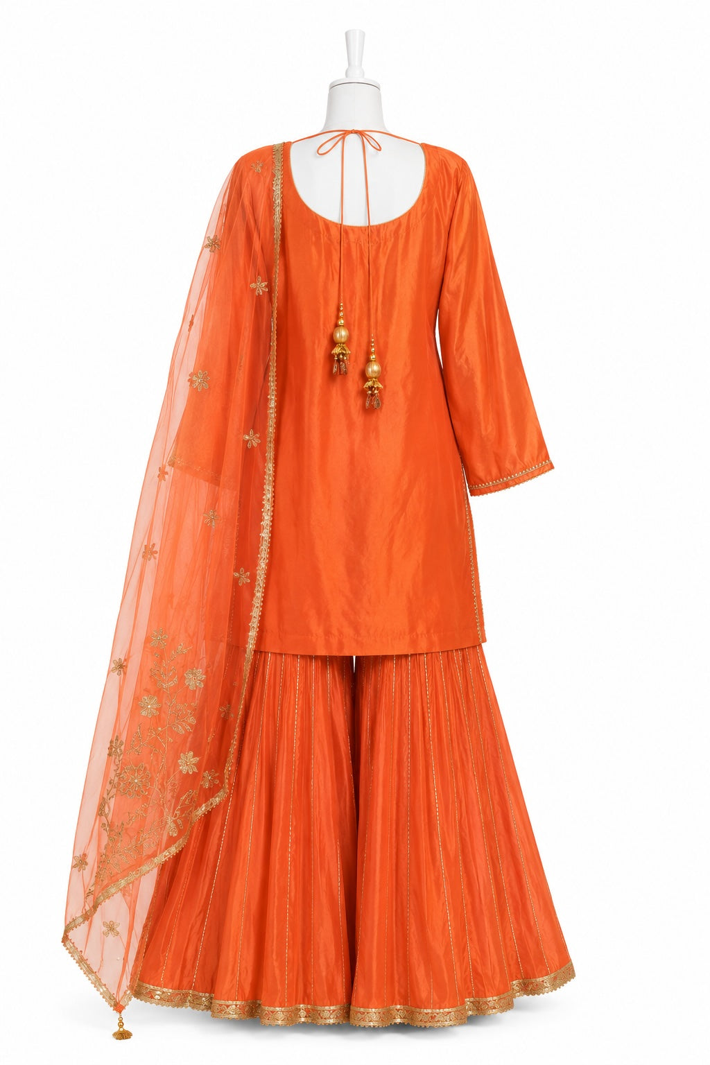 Orange traditional outfit with a sheer dupatta on a white background