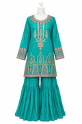 Teal embroidered traditional outfit on a mannequin against a white background