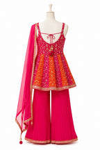 Traditional outfit with a pink and orange top and pants on a mannequin against a white background