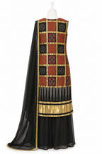 Traditional outfit with a patterned top and black skirt on a white background
